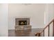 Open-concept living area featuring a stone fireplace with wood-style floors and high ceilings at 122 W Cottage Ln, Tempe, AZ 85282