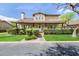 Charming two-story home featuring a covered front porch, lush landscaping, and a welcoming entrance at 122 W Cottage Ln, Tempe, AZ 85282