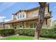 Charming two-story home featuring a covered front porch, lush landscaping, and a welcoming entrance at 122 W Cottage Ln, Tempe, AZ 85282