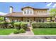 Charming two-story home featuring a covered front porch, lush landscaping, and a welcoming entrance at 122 W Cottage Ln, Tempe, AZ 85282