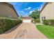 A driveway leads to a 2 car garage, with green grass on the side at 122 W Cottage Ln, Tempe, AZ 85282
