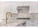 Kitchen with stainless steel hood range and stone backsplash at 122 W Cottage Ln, Tempe, AZ 85282