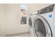 Laundry room with tiled floor, modern washer and dryer, and bright window at 122 W Cottage Ln, Tempe, AZ 85282