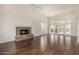 Spacious living room featuring hardwood floors, a stone fireplace, and plenty of natural light at 122 W Cottage Ln, Tempe, AZ 85282