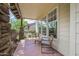 This charming covered patio features stone pillars and a seating area with comfortable striped cushions at 122 W Cottage Ln, Tempe, AZ 85282