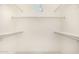 Walk-in closet with ample shelving and natural light from a small window for efficient storage at 122 W Cottage Ln, Tempe, AZ 85282