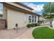 Well-maintained yard with manicured landscaping, brick path, and stone accents leading to an outdoor kitchen area at 122 W Cottage Ln, Tempe, AZ 85282