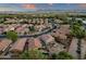 Lush suburban neighborhood captured from above, highlighting varied homes, green spaces, and scenic mountain views at 20848 E Desert Hills Blvd, Queen Creek, AZ 85142