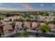 Scenic aerial view of a residential area with lush greenery, manicured lawns, and orderly street layout at sunset at 20848 E Desert Hills Blvd, Queen Creek, AZ 85142