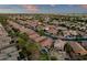 Wide aerial shot showcasing an orderly community of homes, lush greenery, and a pristine pool at 20848 E Desert Hills Blvd, Queen Creek, AZ 85142