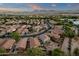Wide aerial view of neighborhood displaying houses with tiled roofs and desert-style landscaping at 20848 E Desert Hills Blvd, Queen Creek, AZ 85142