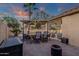 Inviting outdoor patio with dining area, pool view, and stylish furnishings under an illuminated umbrella at 20848 E Desert Hills Blvd, Queen Creek, AZ 85142