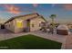 Exterior view of home, showcasing the backyard, pool and patio space with comfortable lounge seating and desert landscaping at 20848 E Desert Hills Blvd, Queen Creek, AZ 85142