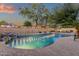 Private backyard pool surrounded by mature trees and desert landscaping, offering a tranquil retreat at 20848 E Desert Hills Blvd, Queen Creek, AZ 85142