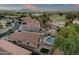 Aerial view showcasing a private backyard pool, patio with seating and manicured landscaping at 20848 E Desert Hills Blvd, Queen Creek, AZ 85142