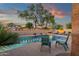 Serene backyard with a refreshing pool, complemented by comfortable seating and charming desert plants at 20848 E Desert Hills Blvd, Queen Creek, AZ 85142