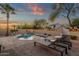 Inviting backyard featuring a pool, lush desert landscaping, and comfortable lounge seating for ultimate relaxation at 20848 E Desert Hills Blvd, Queen Creek, AZ 85142