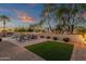 Spacious backyard featuring a pool, well-manicured turf, and comfortable lounge seating, perfect for outdoor activities at 20848 E Desert Hills Blvd, Queen Creek, AZ 85142
