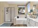 Bright bathroom featuring a soaking tub under a large window, walk-in shower and vanity with sink at 20848 E Desert Hills Blvd, Queen Creek, AZ 85142