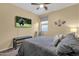 Comfortable bedroom with mounted television, chair, bed and bench at 20848 E Desert Hills Blvd, Queen Creek, AZ 85142