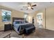 Primary bedroom with neutral tones, soft carpet, and ensuite bath with archway entrance at 20848 E Desert Hills Blvd, Queen Creek, AZ 85142
