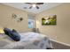 Inviting bedroom featuring a TV, ceiling fan, and a calming space for rest and relaxation at 20848 E Desert Hills Blvd, Queen Creek, AZ 85142