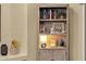 Close up of a bookcase with decorative items and books, softly lit at 20848 E Desert Hills Blvd, Queen Creek, AZ 85142