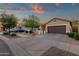 Exterior shot of a single Gathering home with desert landscaping and a two car garage at 20848 E Desert Hills Blvd, Queen Creek, AZ 85142