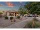 A single-Gathering home with a beautiful xeriscaped front yard and a quaint front porch at 20848 E Desert Hills Blvd, Queen Creek, AZ 85142