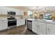 Bright kitchen with quartz counters, stainless appliances, white cabinets and adjacent dining area at 20848 E Desert Hills Blvd, Queen Creek, AZ 85142