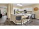 Kitchen with quartz counters, stainless appliances, white cabinets and adjacent breakfast bar seating at 20848 E Desert Hills Blvd, Queen Creek, AZ 85142
