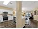 Open concept kitchen with quartz counters and stainless appliances connects to a cozy Gathering room at 20848 E Desert Hills Blvd, Queen Creek, AZ 85142