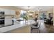 Bright kitchen boasts quartz counters, a breakfast bar, stainless appliances, and access to the backyard at 20848 E Desert Hills Blvd, Queen Creek, AZ 85142