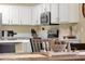 Kitchen with white cabinets, stainless steel appliances, and a breakfast bar at 20848 E Desert Hills Blvd, Queen Creek, AZ 85142