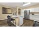 Open-concept kitchen with stainless steel appliances, an island, and barstool seating at 20848 E Desert Hills Blvd, Queen Creek, AZ 85142