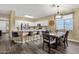 Kitchen with stainless steel appliances, an island, and an adjacent dining area at 20848 E Desert Hills Blvd, Queen Creek, AZ 85142