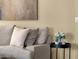 Living room accent detail showing a comfortable sectional sofa, decorative pillows, and a stylish side table at 20848 E Desert Hills Blvd, Queen Creek, AZ 85142