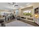 Inviting living room with a flat-screen TV, ceiling fan, and hardwood floors at 20848 E Desert Hills Blvd, Queen Creek, AZ 85142