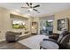 Open concept living room with large windows and sliding doors to the backyard at 20848 E Desert Hills Blvd, Queen Creek, AZ 85142