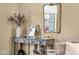 Living room console table with stylish decor and a decorative mirror creating an inviting accent at 20848 E Desert Hills Blvd, Queen Creek, AZ 85142