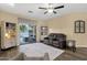 Cozy living room with a couch, bookcase, and sliding glass doors to the patio at 20848 E Desert Hills Blvd, Queen Creek, AZ 85142