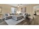 Spacious living room featuring a cozy sectional sofa and large windows for ample natural light at 20848 E Desert Hills Blvd, Queen Creek, AZ 85142