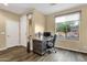Bright office space featuring hardwood floors, a desk, and a large window at 20848 E Desert Hills Blvd, Queen Creek, AZ 85142