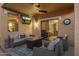 Relaxing outdoor patio with stylish seating, fire pit, and television for entertainment and comfort at 20848 E Desert Hills Blvd, Queen Creek, AZ 85142