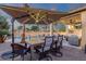 Spacious outdoor patio with dining area, pool view, and ambient lighting perfect for gatherings and relaxation at 20848 E Desert Hills Blvd, Queen Creek, AZ 85142