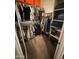 Organized walk-in closet featuring double hanging rods and built-in shelving for optimal storage solutions at 26232 N 121St Ln, Peoria, AZ 85383