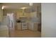 An open kitchen featuring modern white appliances and adjacent living room at 2650 W Union Hills Dr # 43, Phoenix, AZ 85027