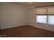 Bright living room featuring a large window with blinds at 2650 W Union Hills Dr # 43, Phoenix, AZ 85027
