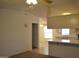 Open living room featuring a kitchen and adjacent room with bright lighting at 2650 W Union Hills Dr # 43, Phoenix, AZ 85027
