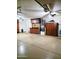 Garage with epoxy flooring, built-in wood cabinets, and overhead lighting and ceiling fan at 343 S Cottonwood St, Chandler, AZ 85225